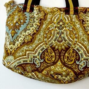 Concalma from Puerto Rico. Velvety bag with elastic handles. Zips close.